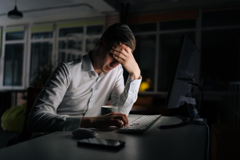 Taxpayer reviewing financial documents and HMRC payment options for outstanding tax bill in the UK