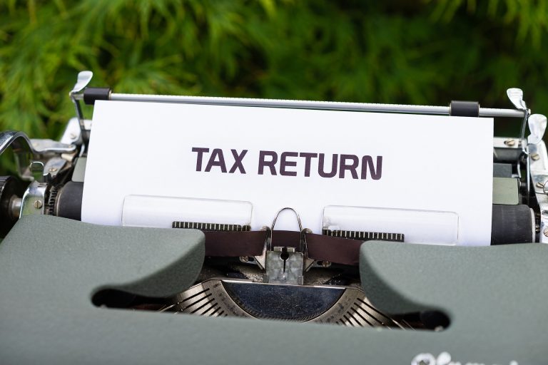 UK taxpayer reviewing overdue tax returns and increasing HMRC penalties and interest